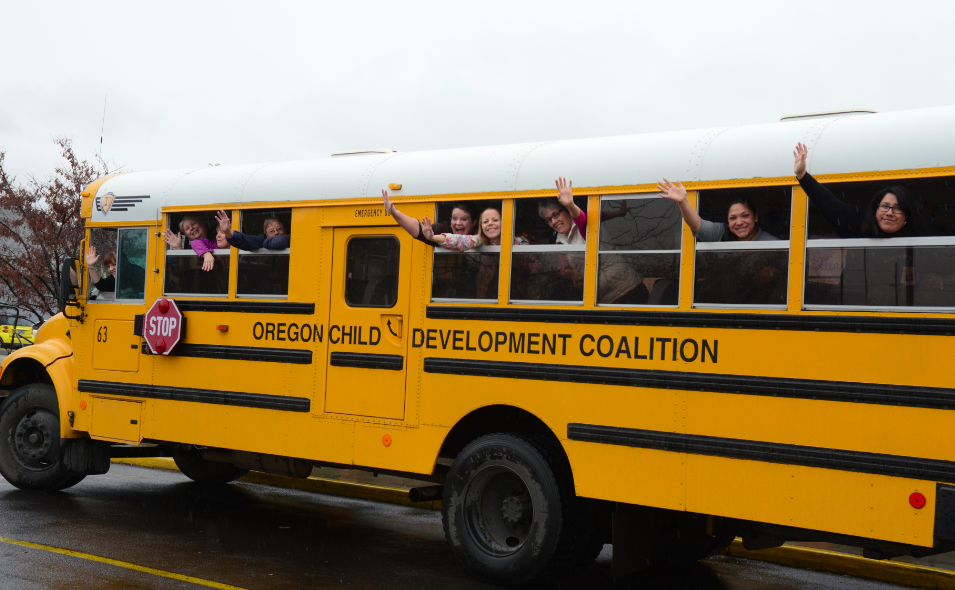 staff waving from an ocdc bus