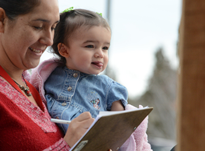 An adult holding a child.