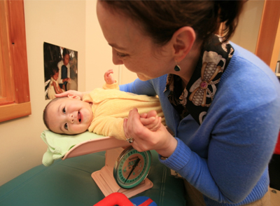 adult holding a smiling infant