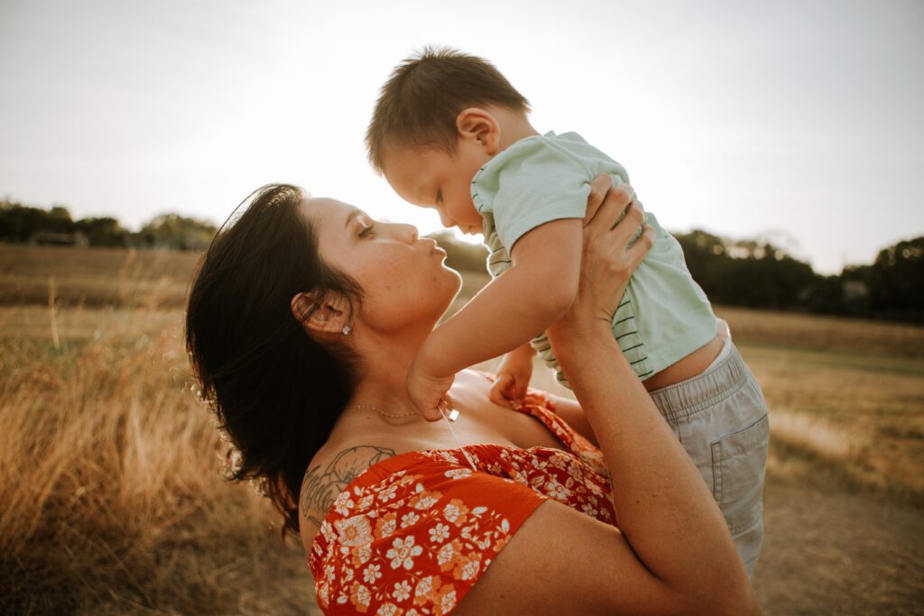 child with adult in the sun