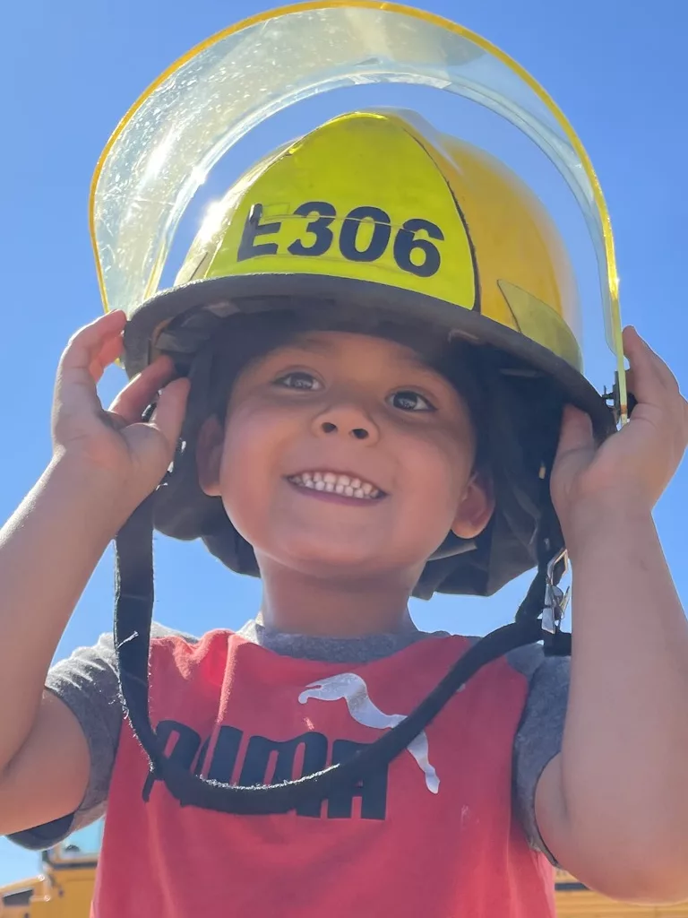 Boy wearing fire helmet
