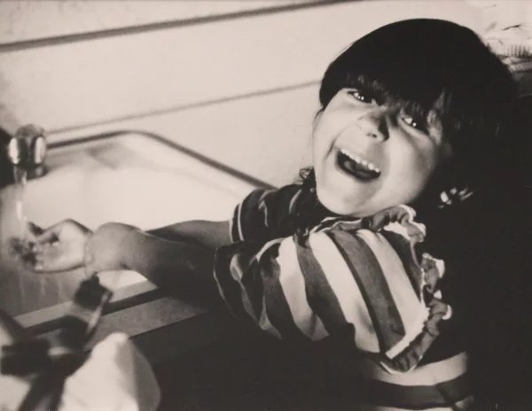 smiling child washing hands